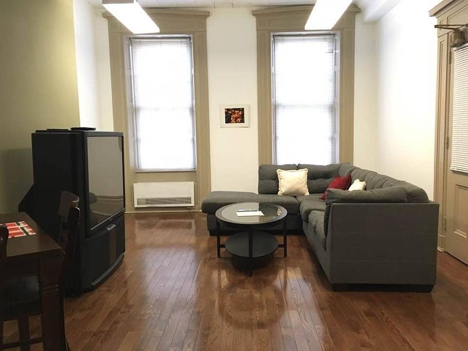 Huge livingroom with a premium TV and sound system