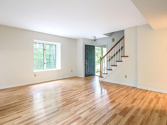 Living room looking back towards front door and stairs leading to the second floor bedrooms