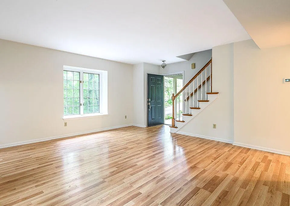 Living room looking back towards front door and stairs leading to the second floor bedrooms