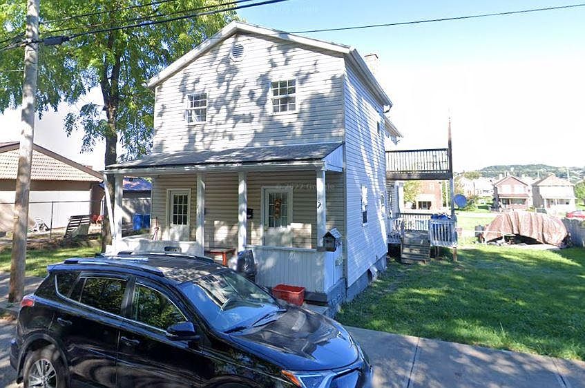 Right side is empty lot for Apt 1, showing deck.