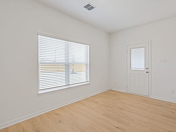 The dining room is open to the kitchen and family room.