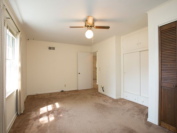 Bedroom 2.  Original hardwoods under the carpet.  2 Closets.