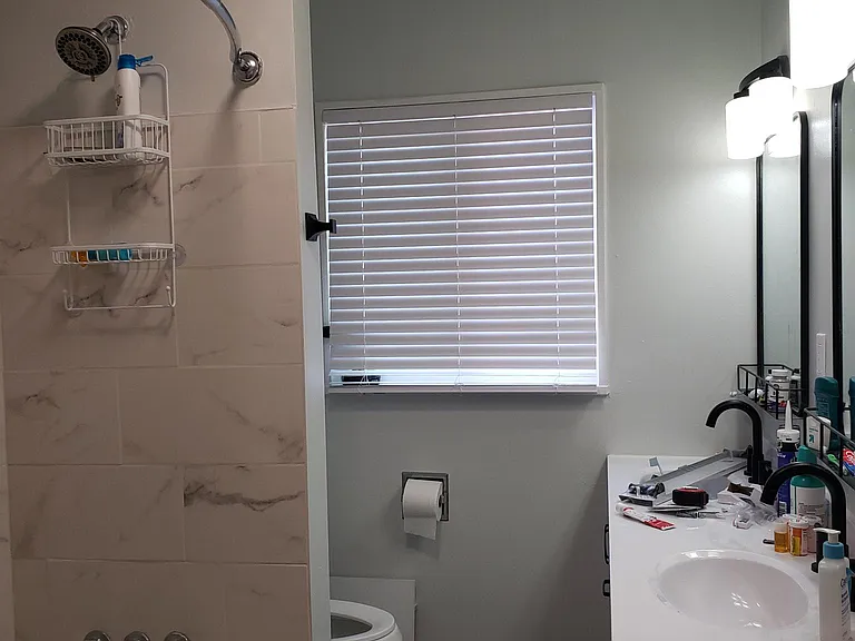 Fully renovated bathroom with two sinks and mirrors