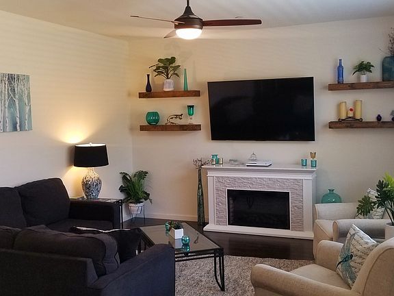 Living room. Lovely faux fireplace. Wall mounted Sony TV included. All of the furniture shown is included. All furniture has just been professionally steam cleaned.