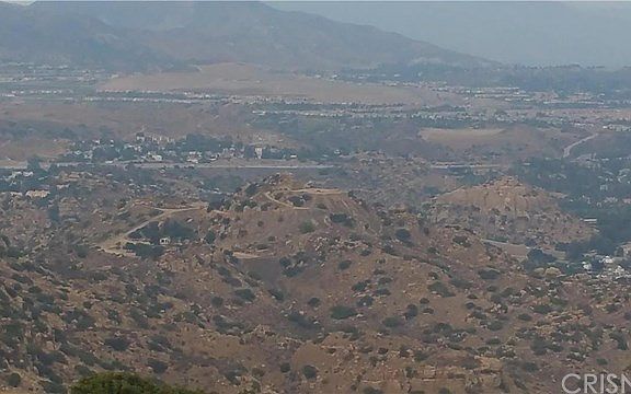 View driving up to the road to the lot. 118 Freeway towards the back drop.