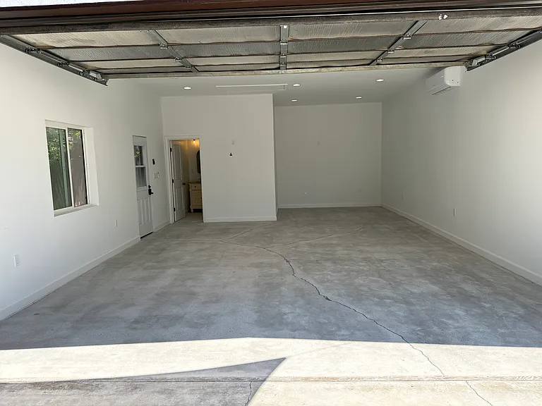 Remodeled detached garage with a large window, full bathroom, separate entrance, heating and air conditioning, dimmable recessed LED lighting, and approximately 545 square feet. Ideal for a home office, gym, creative studio, media room, playroom, etc.