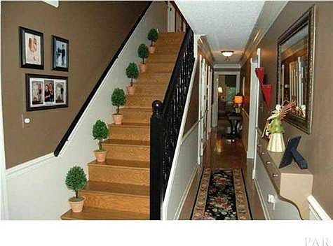 From the front entry foyer, access the dining room to your right or office to your left. Hallway leads to kitchen and lower level master BR. Beautiful stairway to second level.