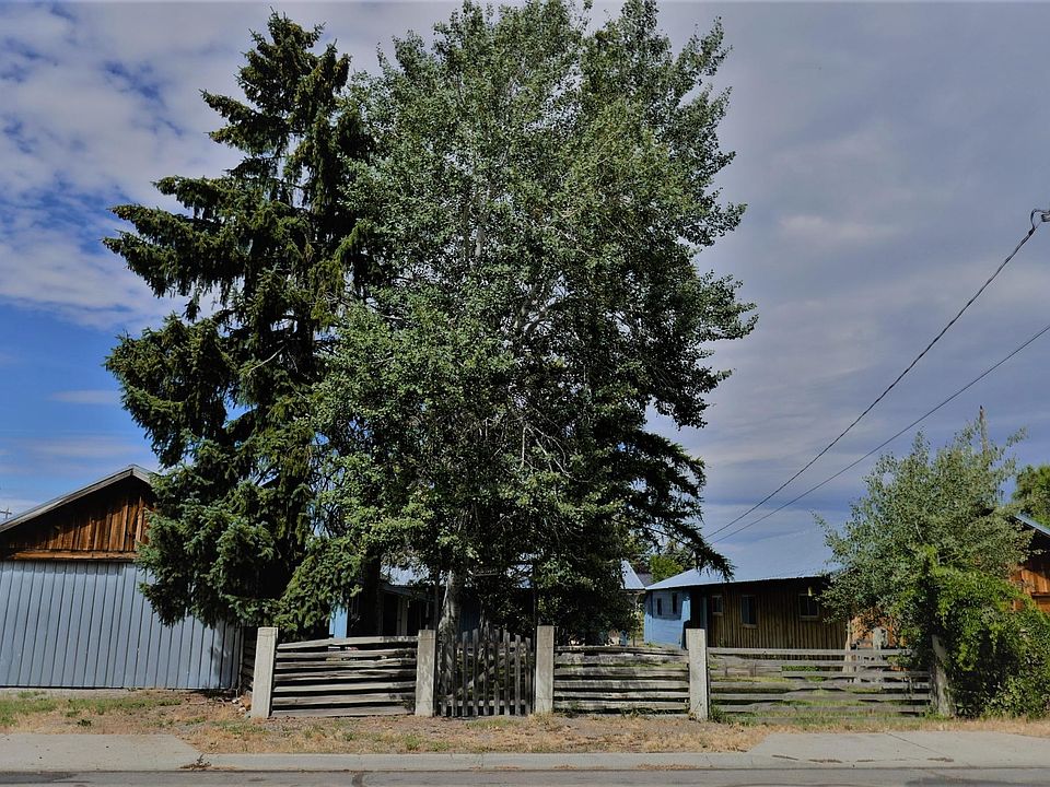 Street view of 2332 Miller Avenue. Garage is on the far left, shop on the right with the house and yard in between. To the side of the garage and shop the property extends 25 ft. to the west and east.