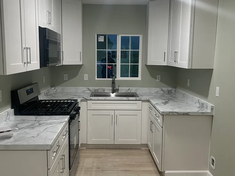 kitchen with gas stove, microwave, and ample cabinet space.