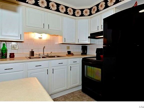 Black smooth top stove and Black refrigerator is included in sale.