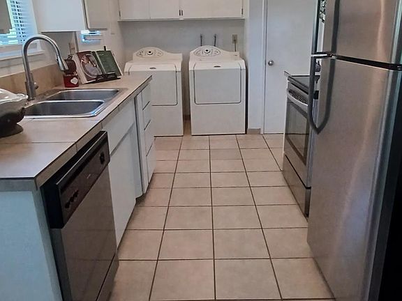 Galley kitchen with stainless steel appliances