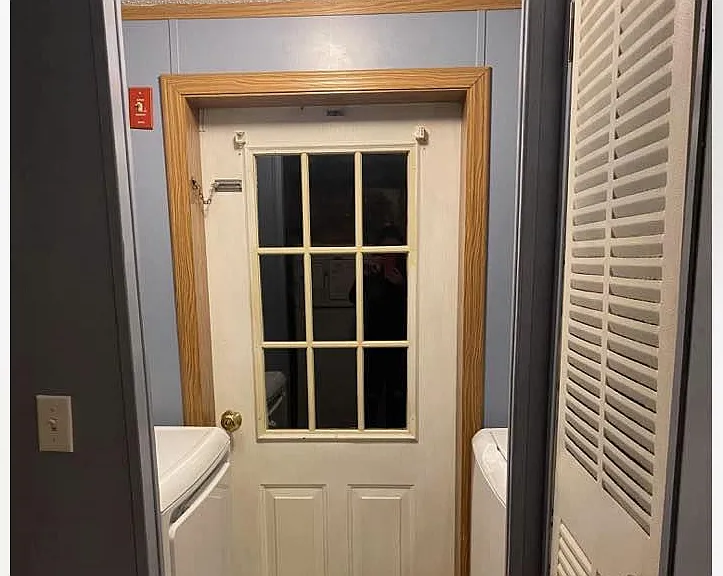 Separate washer and dryer space directly off from the kitchen freshly painted to match the kitchen