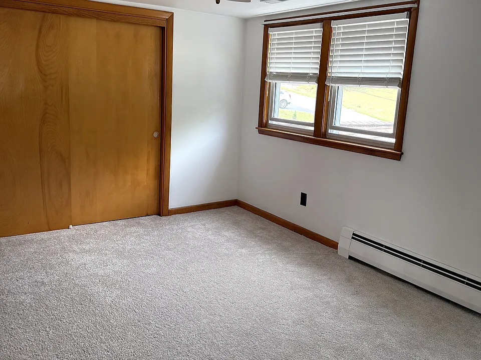 Bedroom with brand new carpet and a wide sliding closet.