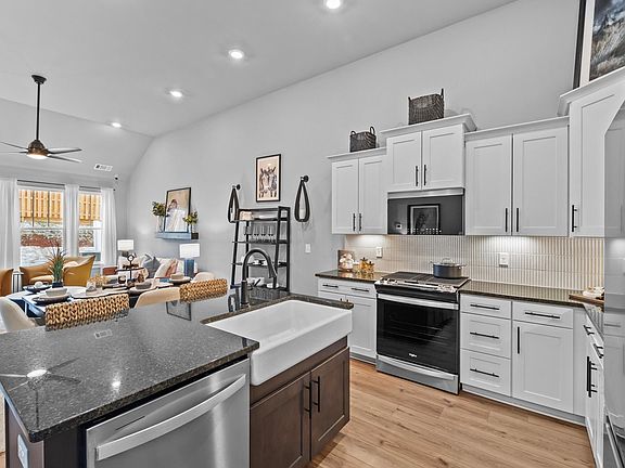 Tasteful kitchen with a streamlined island and modern finishes in a first-class DRB Homes design