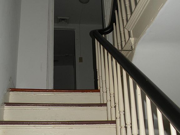 front staircase off the foyer leads to two bedrooms upstairs and one bath. there is additional bedrooms and bath on first floor front of house. Total 6 bedrooms and 4 baths.... unusual set up