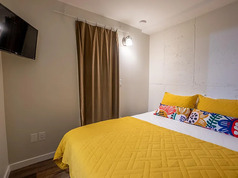 Separate space for queen bed. No doors, only curtains, as it is a studio.