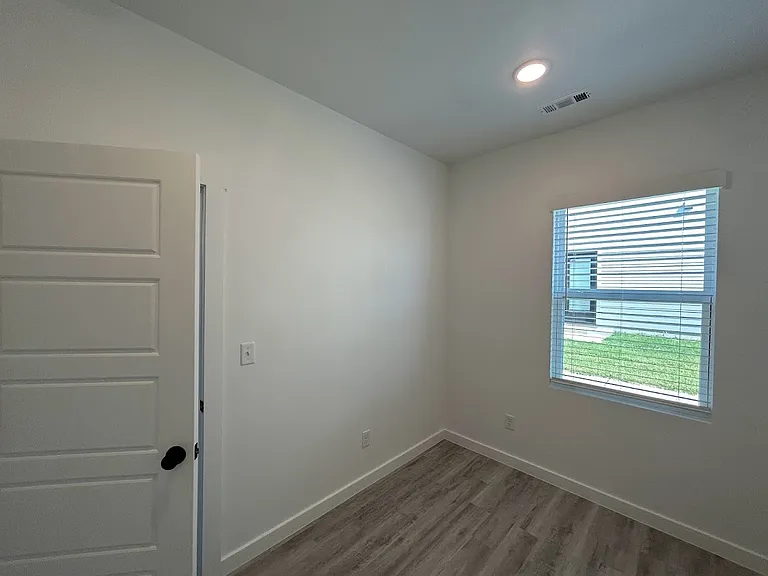 This room is located just off the kitchen and is ideal for an office, work out room or play room.