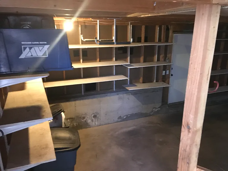 2 car garage with shelving, peg board and large attic storage space