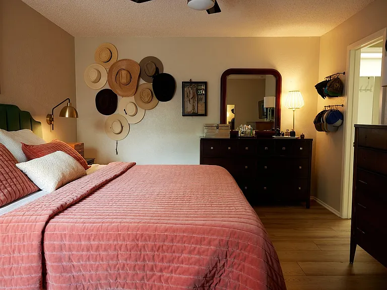 Bedroom with wood finished floors and baseboards