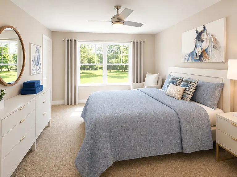 Light-filled bedroom with large window, neutral tones, and spacious layout for comfortable everyday living.