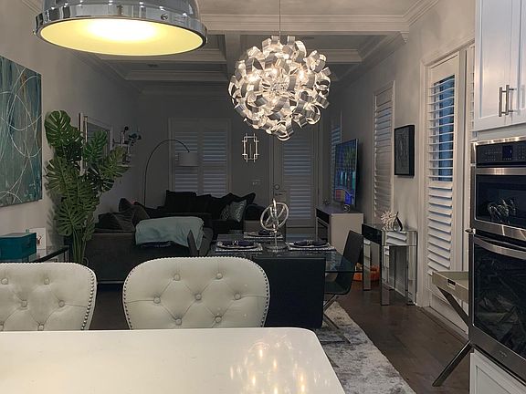 From the kitchen looking into the living room with high end chandelier