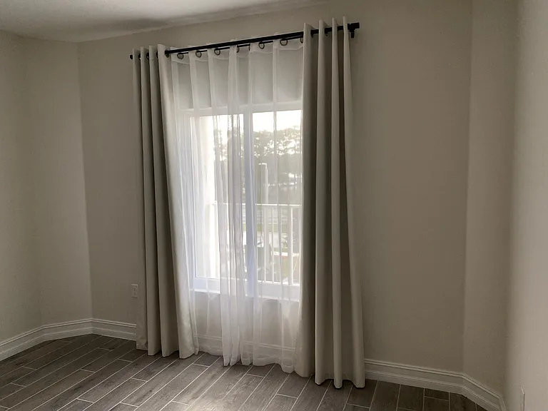 Bedroom #2 with beautiful curtains for privacy and light/heat control.