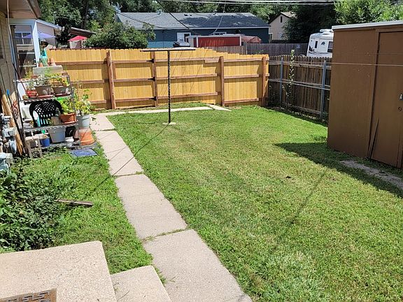 Private and secure fenced rear yard with storage.