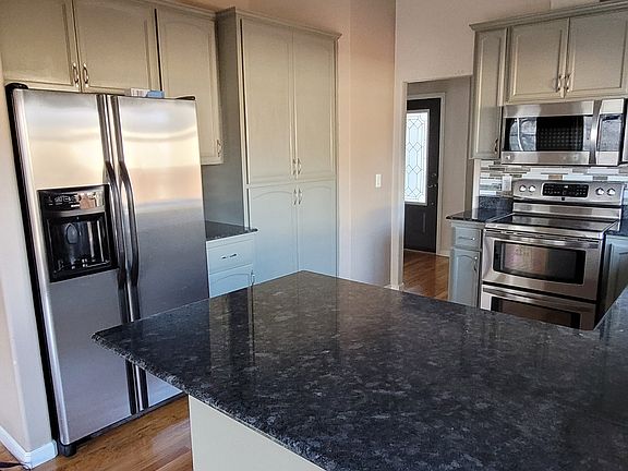 Kitchen with granite countertops and stainless steel appliances