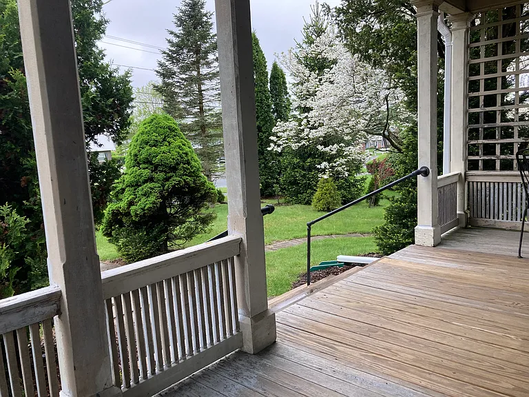 Ascend to Covered Front Porch... giving you time to find your house keys standing under the protection afforded you from the rain and inclement weather