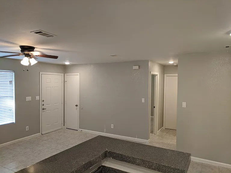 2nd and third bedrooms plus guest full bath via hallway to the right. View from kitchen area