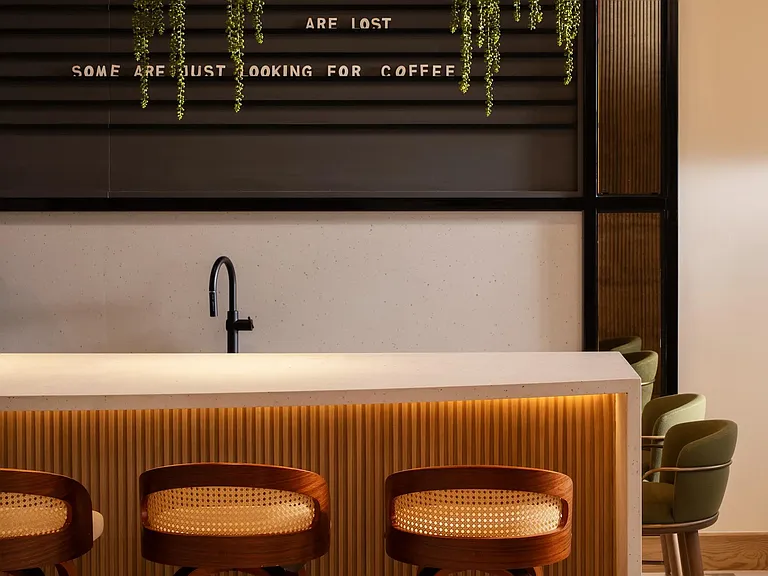 A resident coffee bar with warm wood detailing and ambient lighting_your go-to spot before heading out along Rio Salado.