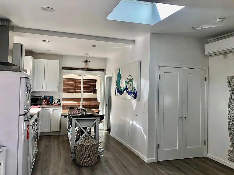 closet, kitchen area and patio doors to pergola area