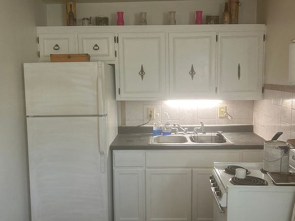 Complete kitchen with full size fridge and apartment size 4-burner stove
