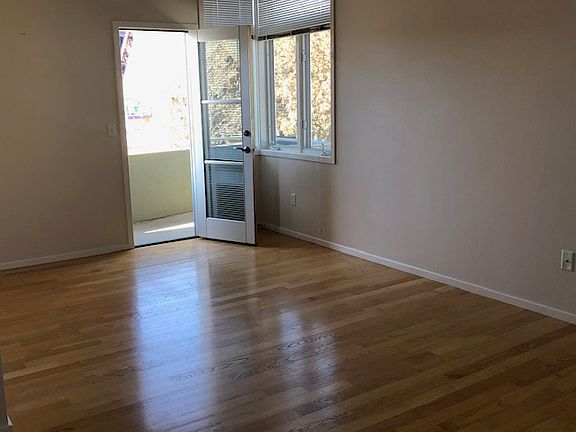 Living area with door leading to balcony and mountain views.