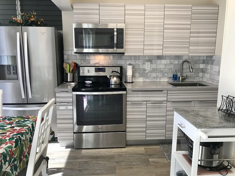 Remodeled kitchen with cook ware and dishes