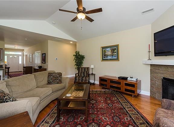 Foyer enters directly to open living area with architectural ceilings