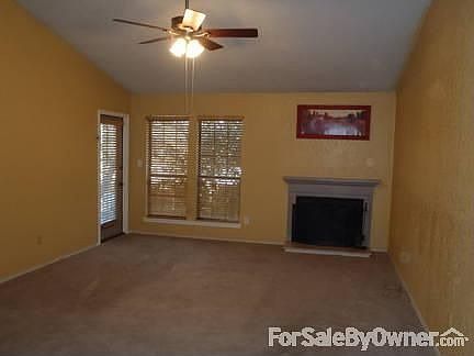 Living Area
						:
						Living area with view of fireplace and balcony door