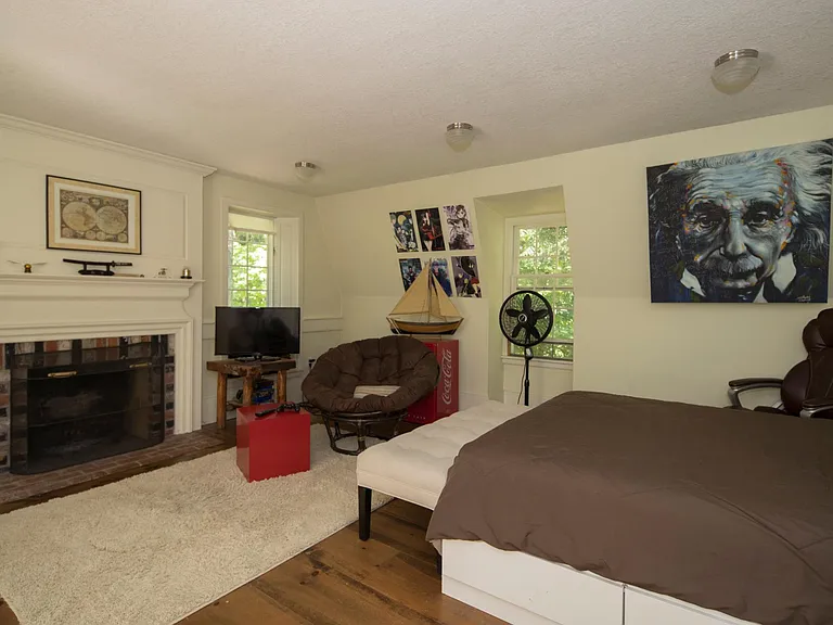 Inlaw bedroom over detached garage, with working fireplace.