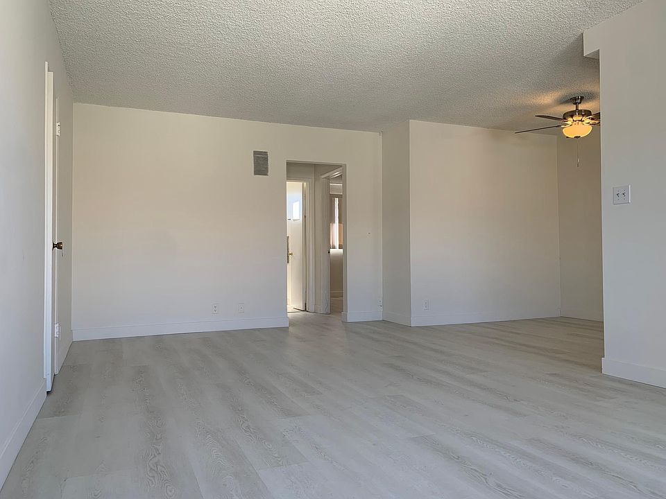 Beautifully redone floors. Ample space in this bright living room. Features a deep storage closet and room for a dining area.