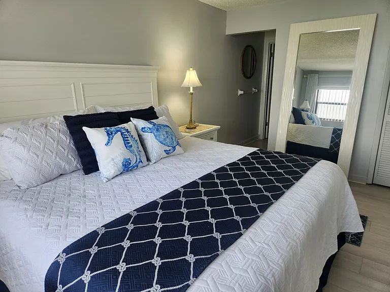 New leaner mirror in master bedroom ( floor mirror ) made of solid wood . Absolutely stunning in this master bedroom with all new furniture .