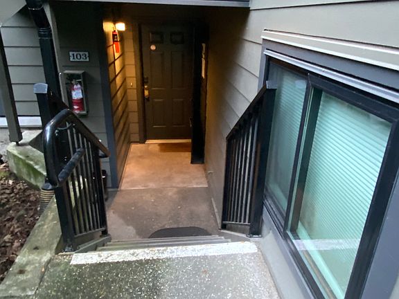 Entry to unit shows new color scheme, new railings and new window in2nd bedroom