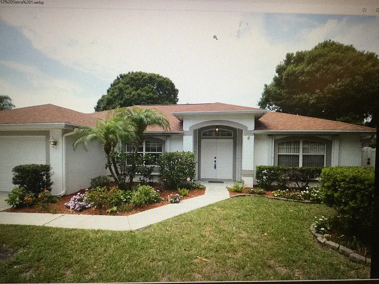 House front landscaped, front door ha seen painted red.