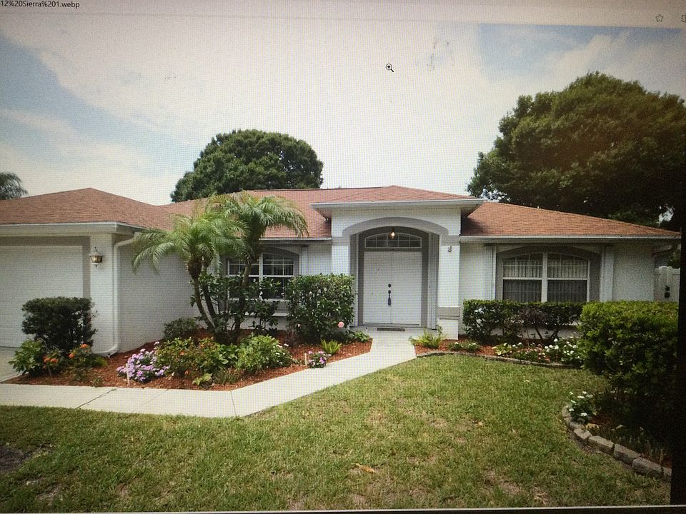 House front landscaped, front door ha seen painted red.