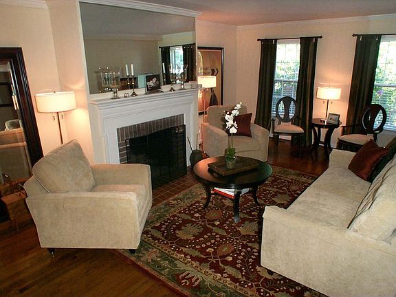 Luxurious Living Room Features a Fireplace and Gorgeous Mantlepiece!