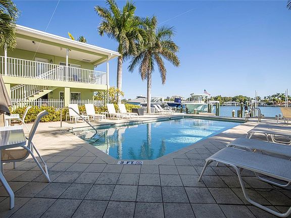 Spacious pool area with a view of the intercoastal waterway.
