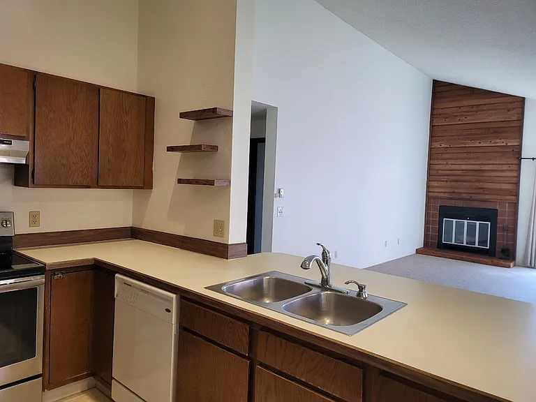 Open living room, dining, and kitchen with cathedral ceilings