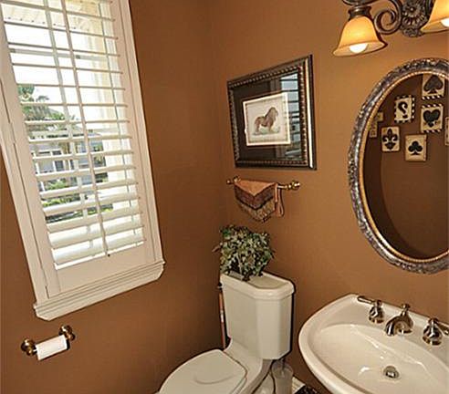 Half bath on 1st floor with plantation shutters.