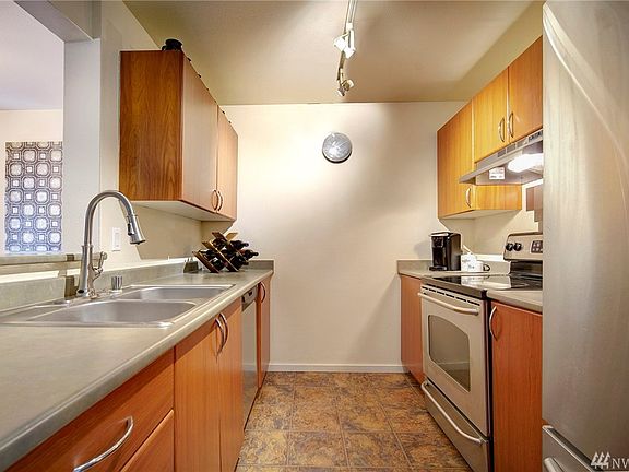 Timeless kitchen has classic counter tops, updated stainless steel appliances, and tons of cabinets!    