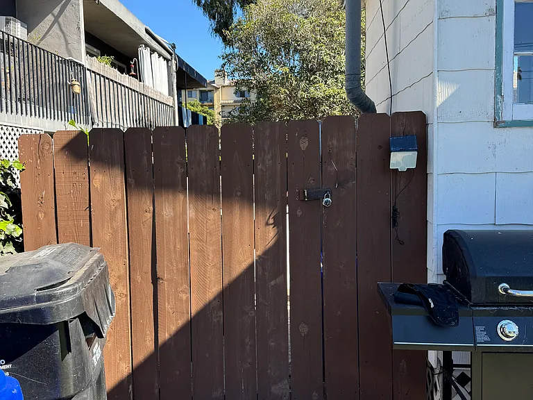 Locked gate and fencing to rear area. Gass grill left by prior renter