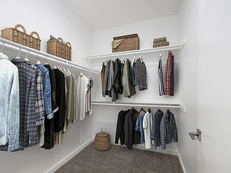Explore this beautifully arranged walk-in closet, perfect for fashion enthusiasts.